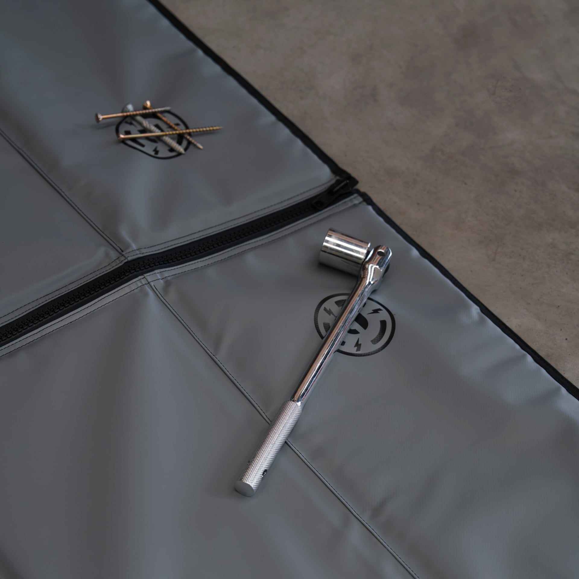 Ratchet and screws resting on the waterproof Pro Mat Plus surface
