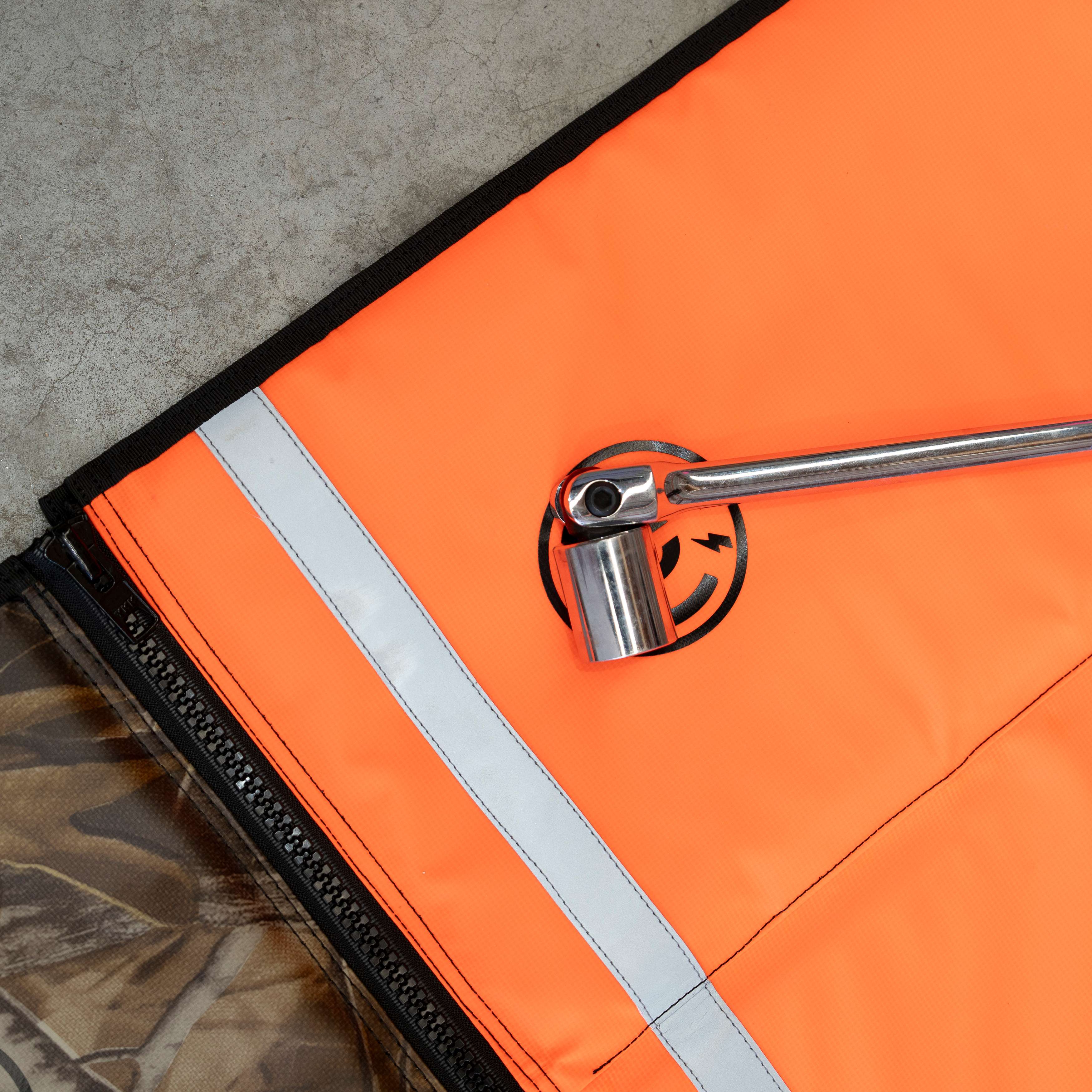 Chrome ratchet held on the magnet-backed corner of a Safety Orange Pro Mat Plus